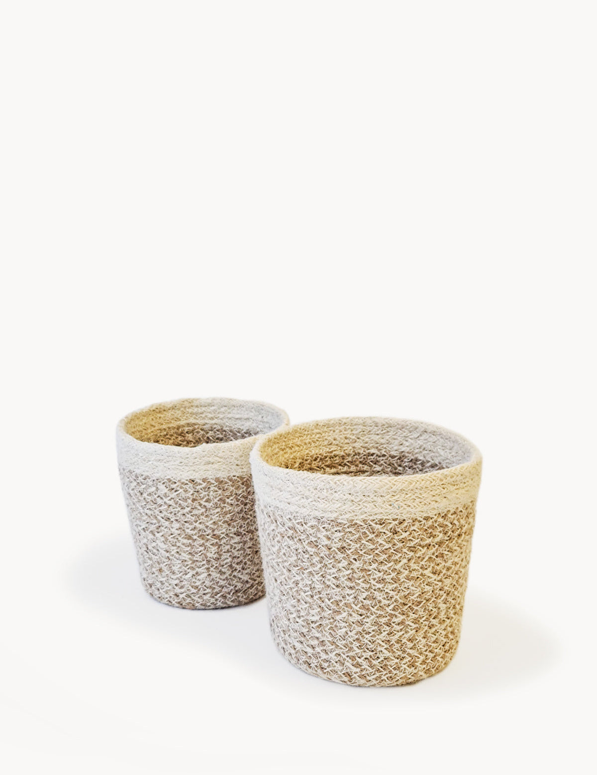 sturdy planter woven from soft jute yarn.  Natural, white. sustainably handmade. 2 sizes. 