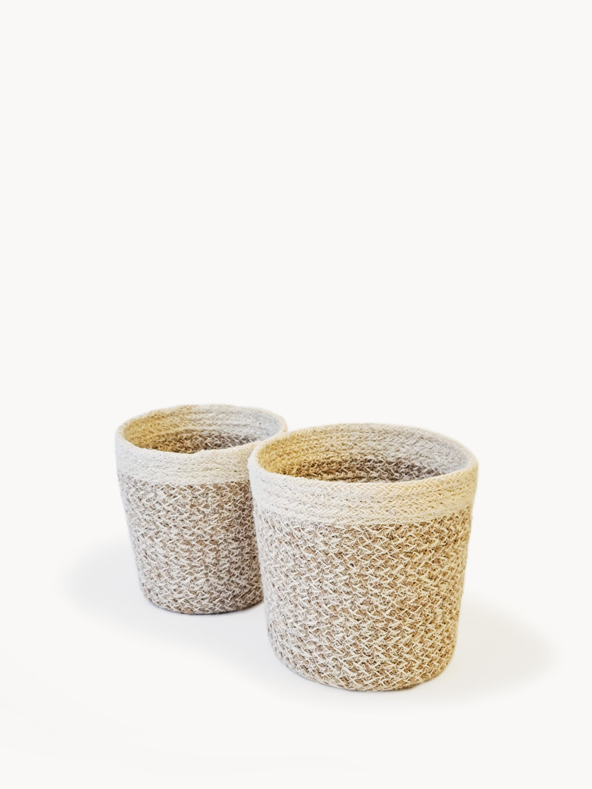 sturdy planter woven from soft jute yarn.  Natural, white. sustainably handmade. 2 sizes. 