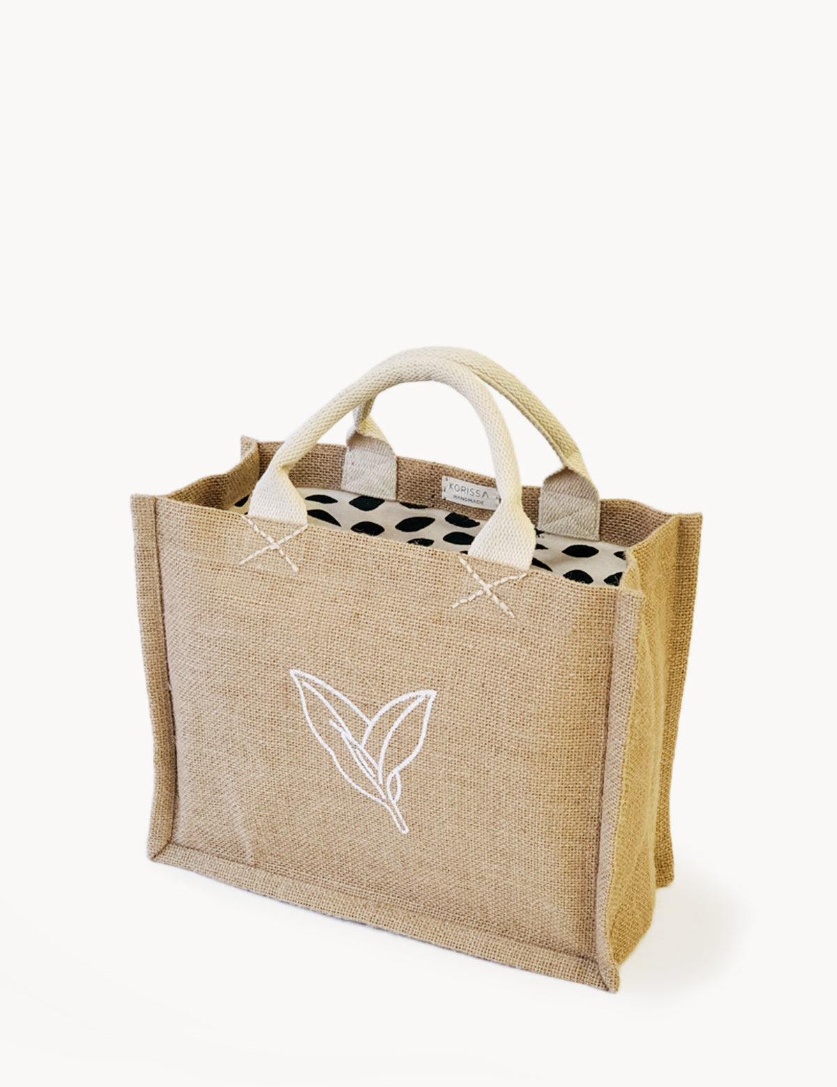 Jute Market Bag. Reusable. Leaf Patter Print. Approximately10” tall x 12.5” wide x 6" deep. Canvas lining with cotton. Colors Natural, White, Green.