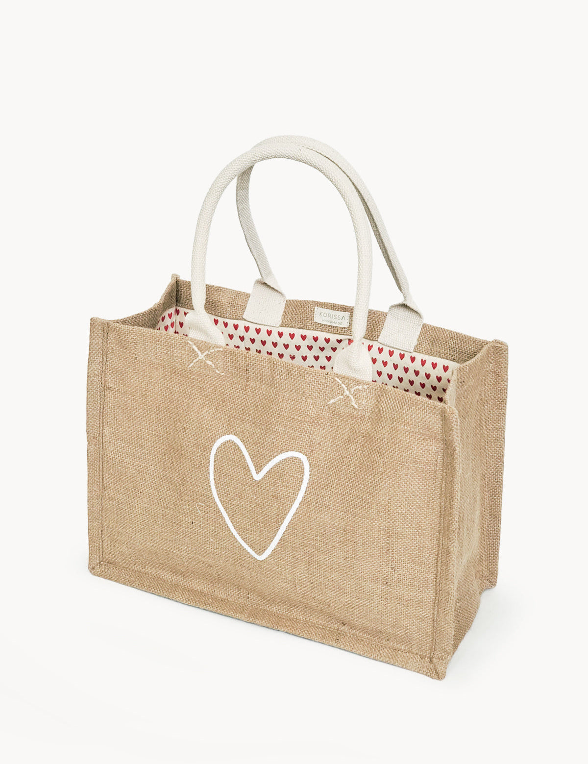 handmade tote bag. market tote. heart print lining. heart print. jute canvas material. 11” tall x 15.5” wide x 7.5" deep.