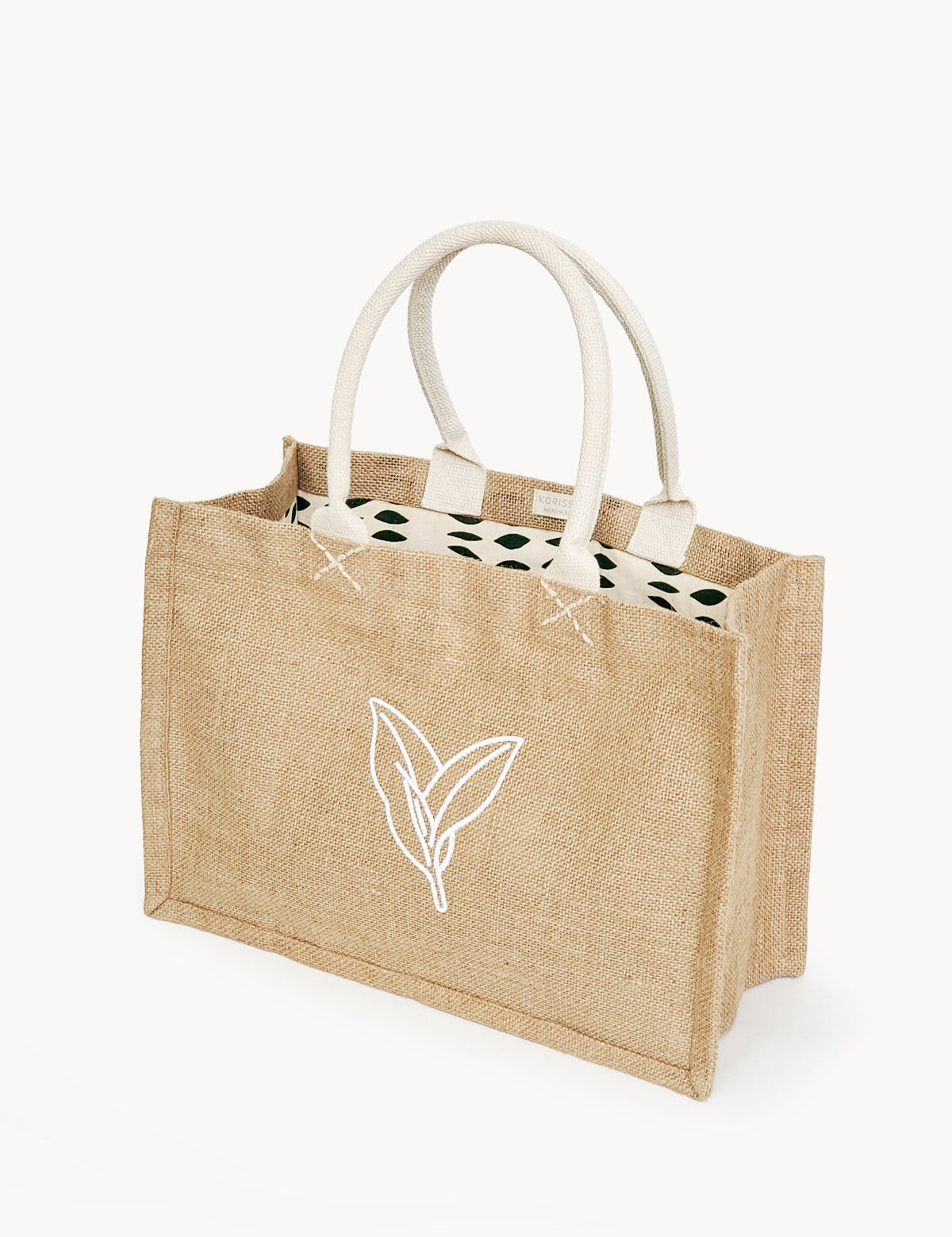 Handmade Jute Market Bag. Reusable. Leaf Patter Print. Approximately 11” tall x 15.5” wide x 7.5" deep. Canvas lining with cotton. Colors Natural, White, Green. 