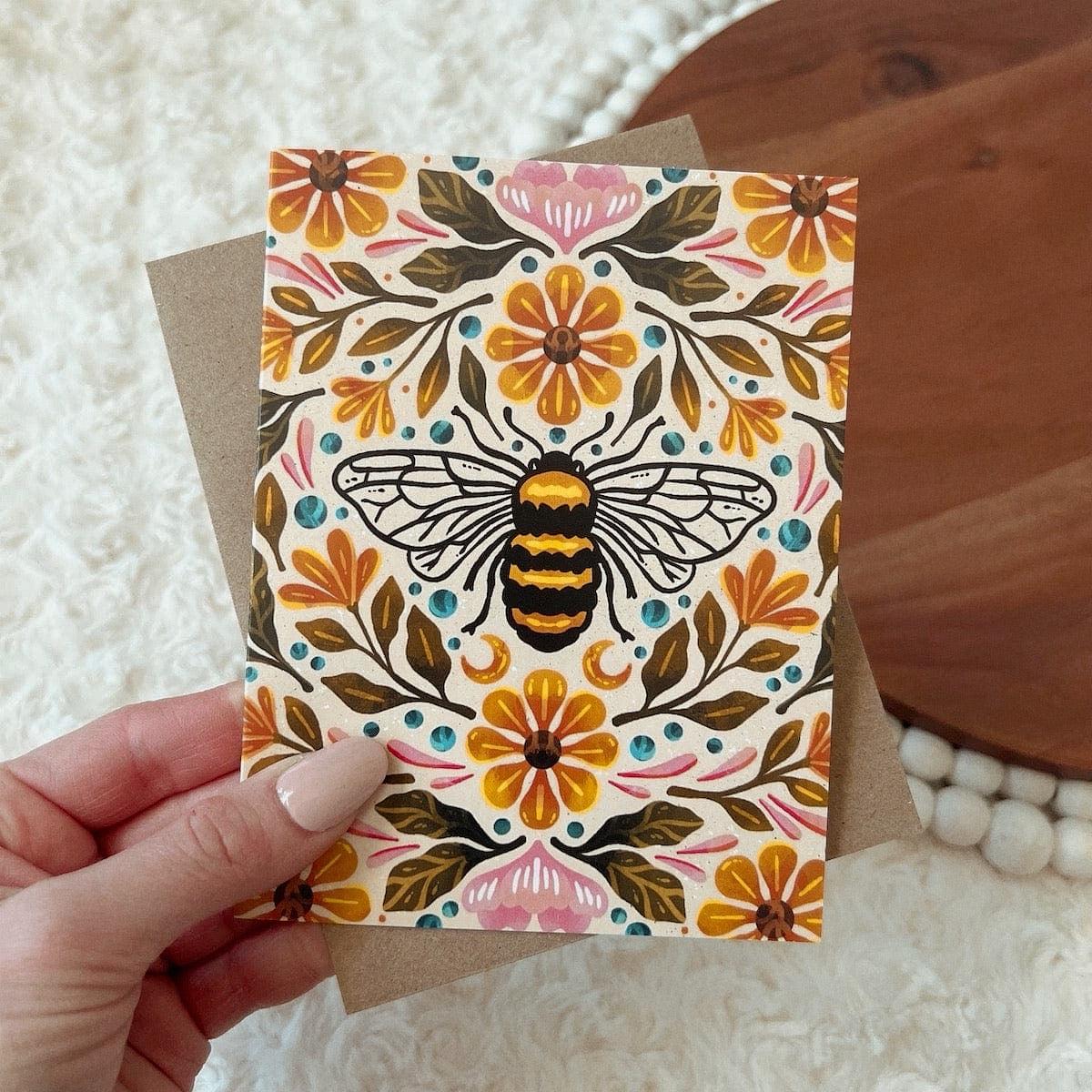 Bee & Floral design. Hand drawn Greeting Card. Hand holding card with envelope. 