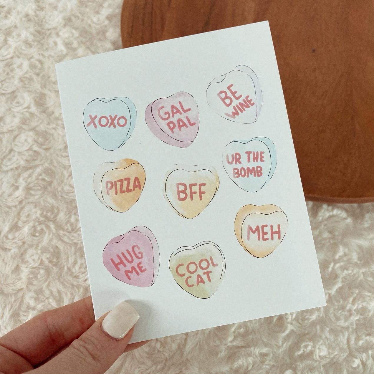 Galentines day Card. Hand drawn candy hearts. Valentine’s Day Card. Hand holding card. 