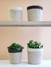 sturdy planter woven from soft jute yarn.  Natural, white. sustainably handmade. 2 sizes. 