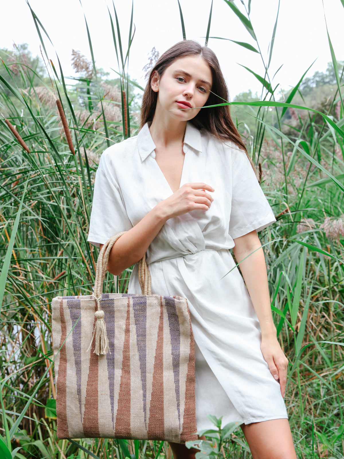 sustainably handmade reusable tote bag. Natural, Blue and Brown in color. Approximately 16”tall x 16"wide / Handle drop 7". 100% Handwoven Jute Fabric