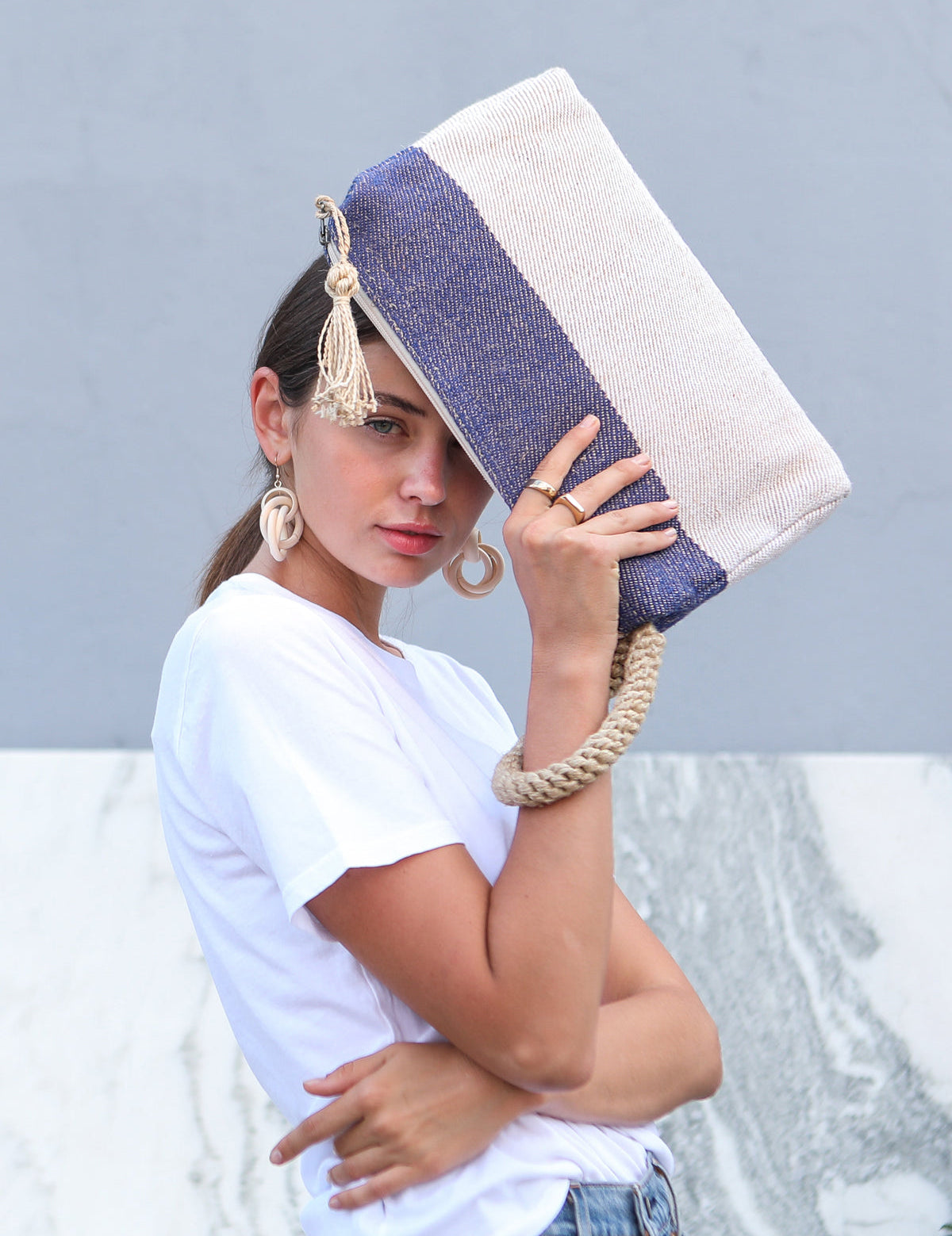  blue and white color block clutch handbag. 100% Handwoven Jute-Cotton Fabric. woven arm strap.small clutch. Approximately 8”tall x 13”wide x 2.25”deep. 100% Handwoven Jute-Cotton Fabric. sustainably handmade.