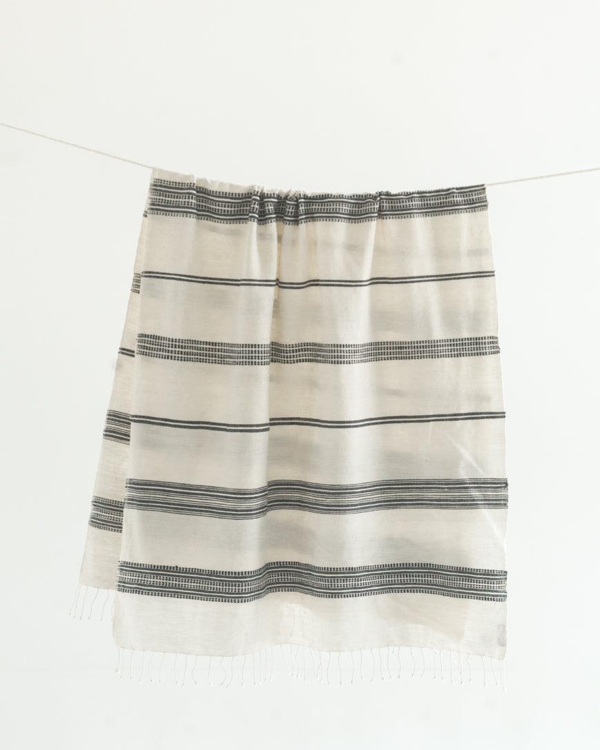 Ethically crafted in Ethiopia. Cotton throw blanket. Measures 38 x 72 inches. natural with grey. 