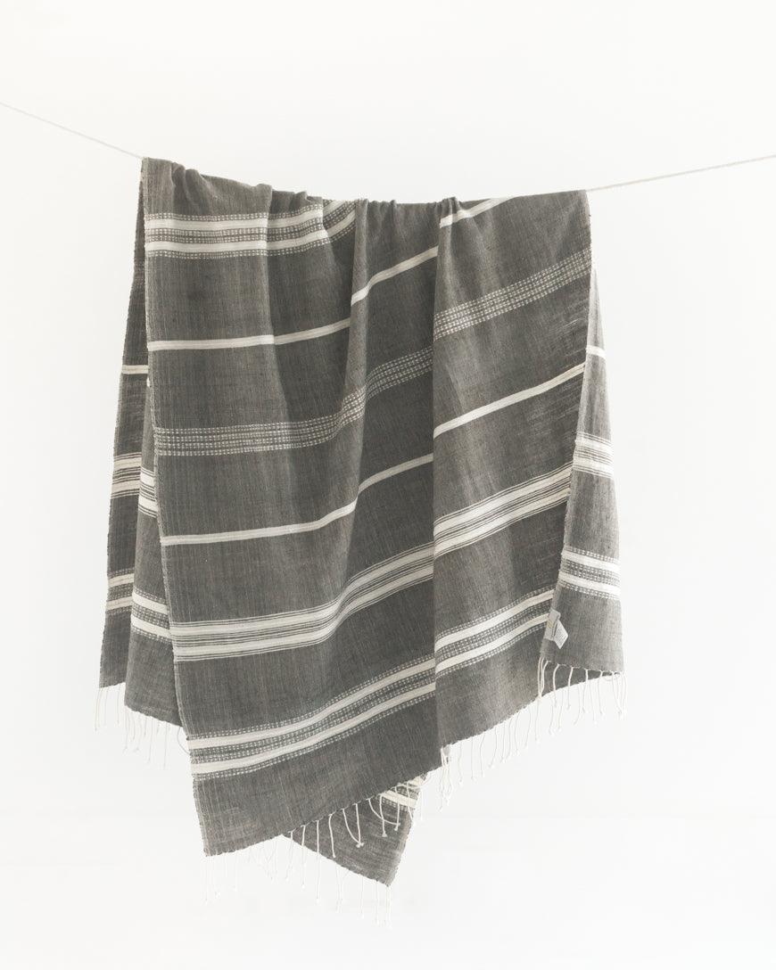 Ethically crafted in Ethiopia. Cotton throw blanket. Measures 38 x 72 inches.  grey with natural. 