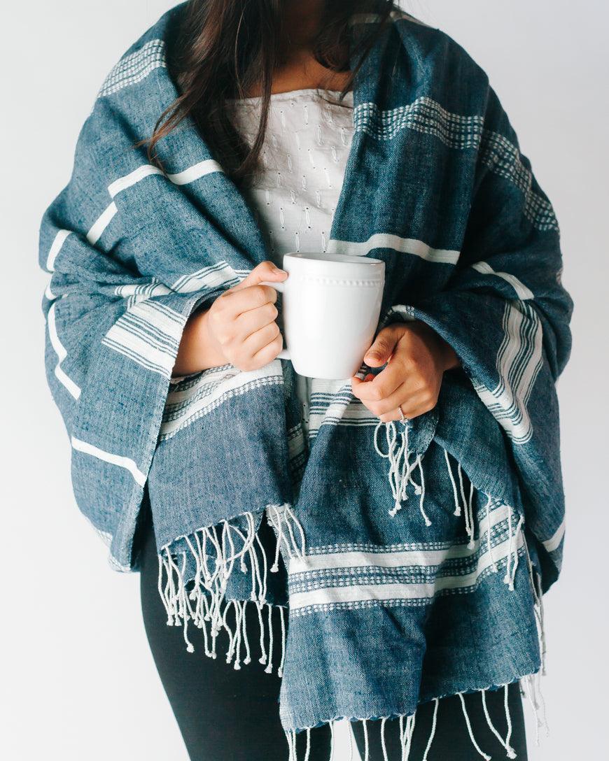 Ethically crafted in Ethiopia. Cotton throw blanket. Measures 38 x 72 inches. navy with natural. 