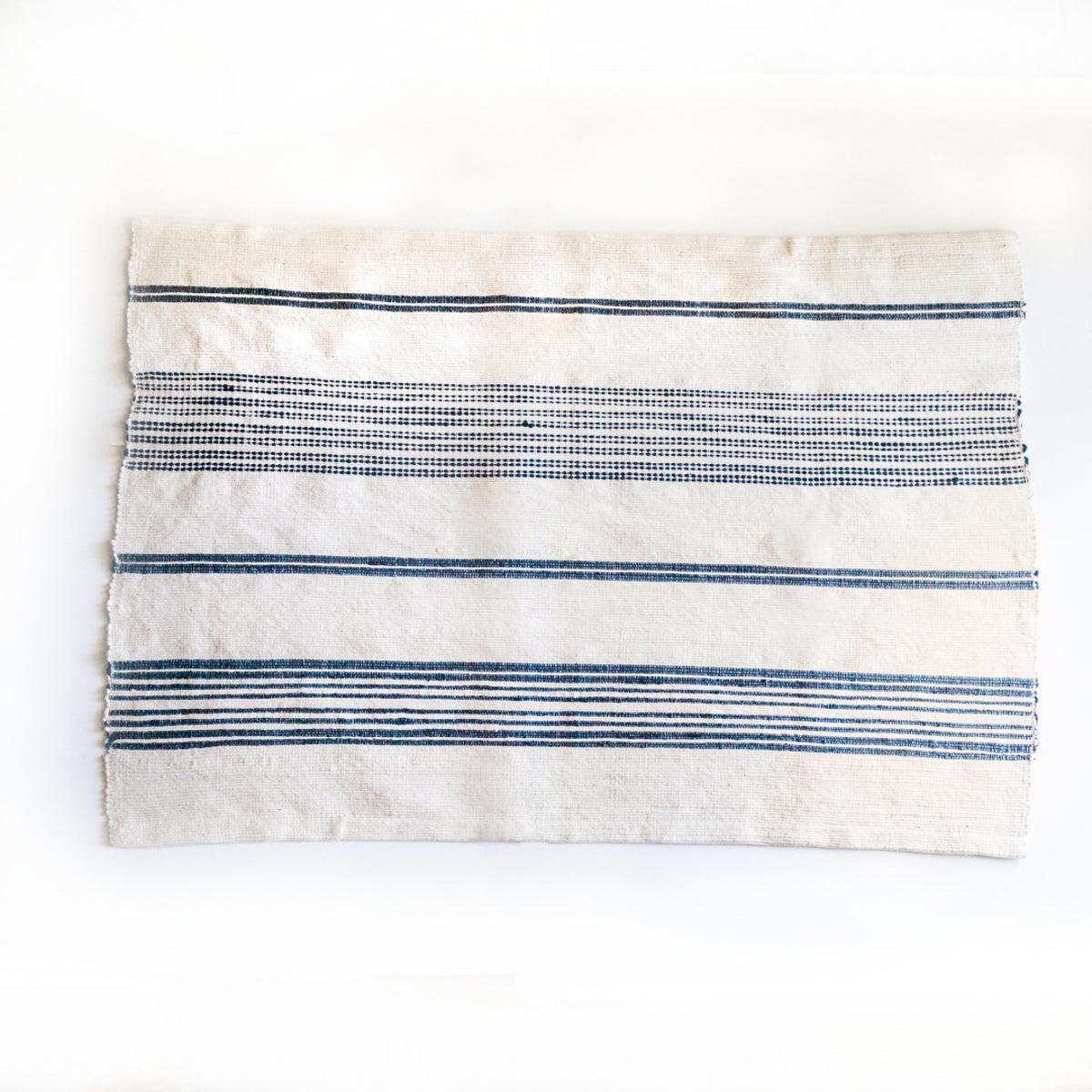 Aden Cotton Bath Mat. 24 x 36 inches.  Hand-spun Ethiopian cotton. woven from thick hand-spun cotton. natural  with navy.. 