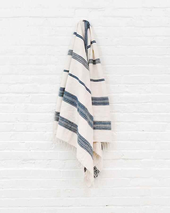 Bath Towel. Measures 38 x 72 inches. Machine wash and dry. ed as bath towels, lightweight shawls and accent throws. AZO-free dyes. hand-woven in Ethiopia. Natural with Navy. 