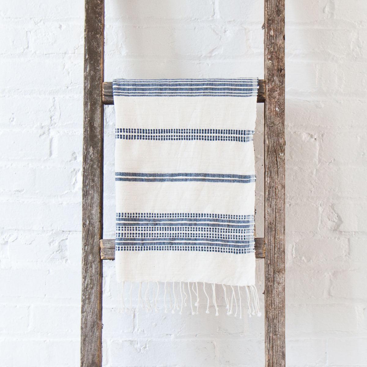 Aden Cotton Hand Towel. Measures 21 x 27 inches. Machine wash and dry.  hand-woven in Ethiopia. 6 color ways. natural with navy..