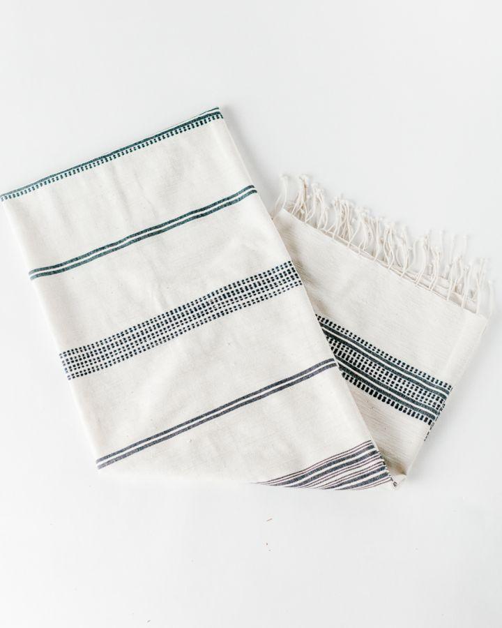 Bath Towel. Measures 38 x 72 inches. Machine wash and dry. ed as bath towels, lightweight shawls and accent throws. AZO-free dyes. hand-woven in Ethiopia. Natural with Navy. 